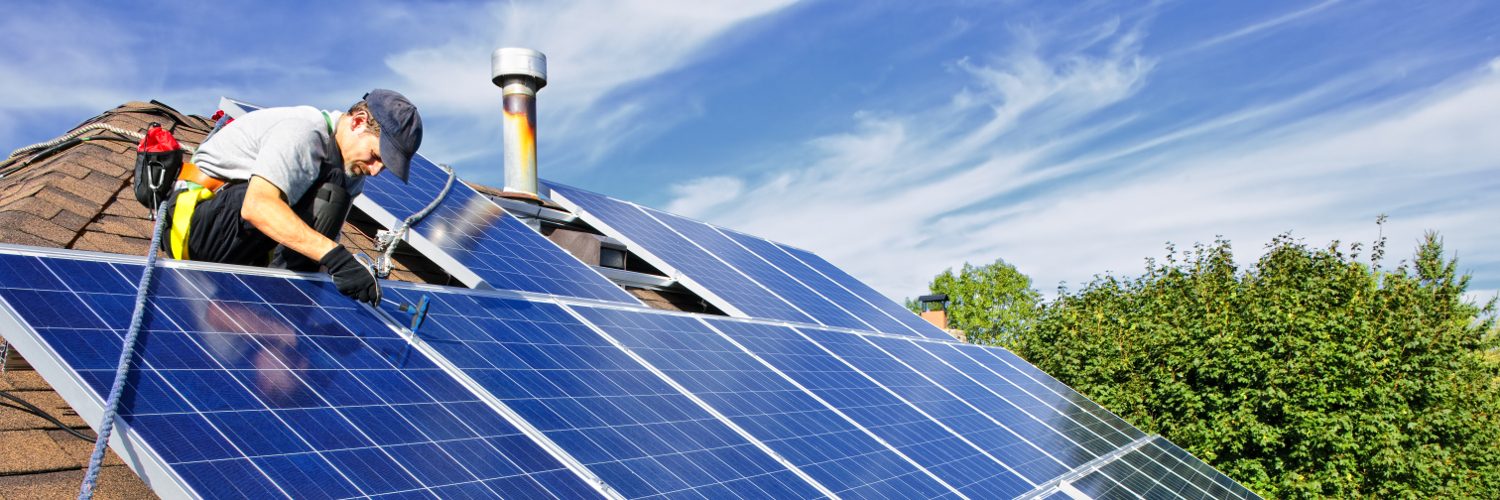 Professional installs solar panels on roof